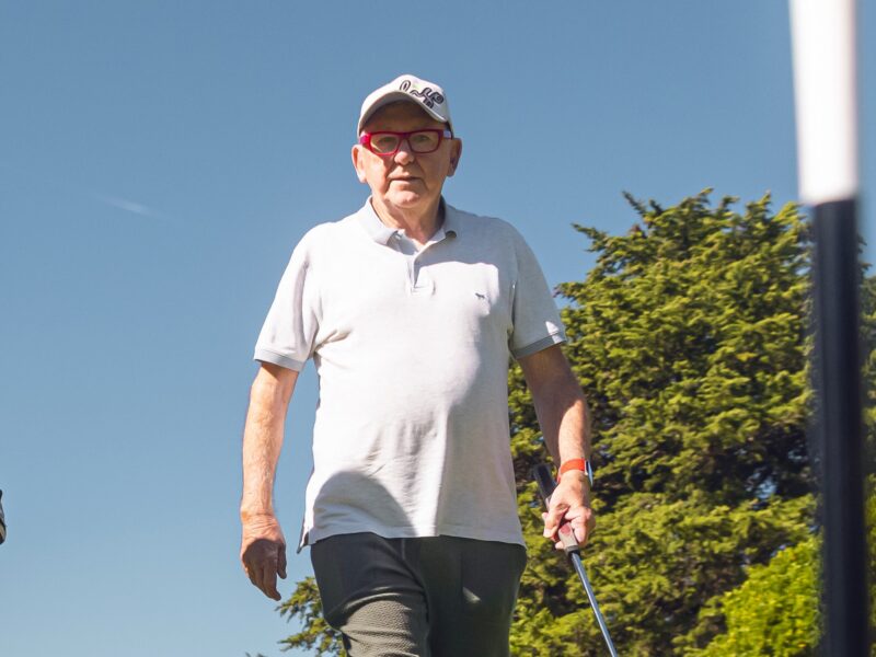 Image of a man with glasses and a cap